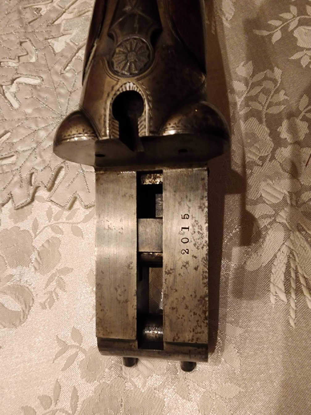 Close-up of the internal hammer action and serial number on the Colt Model 1883 shotgun