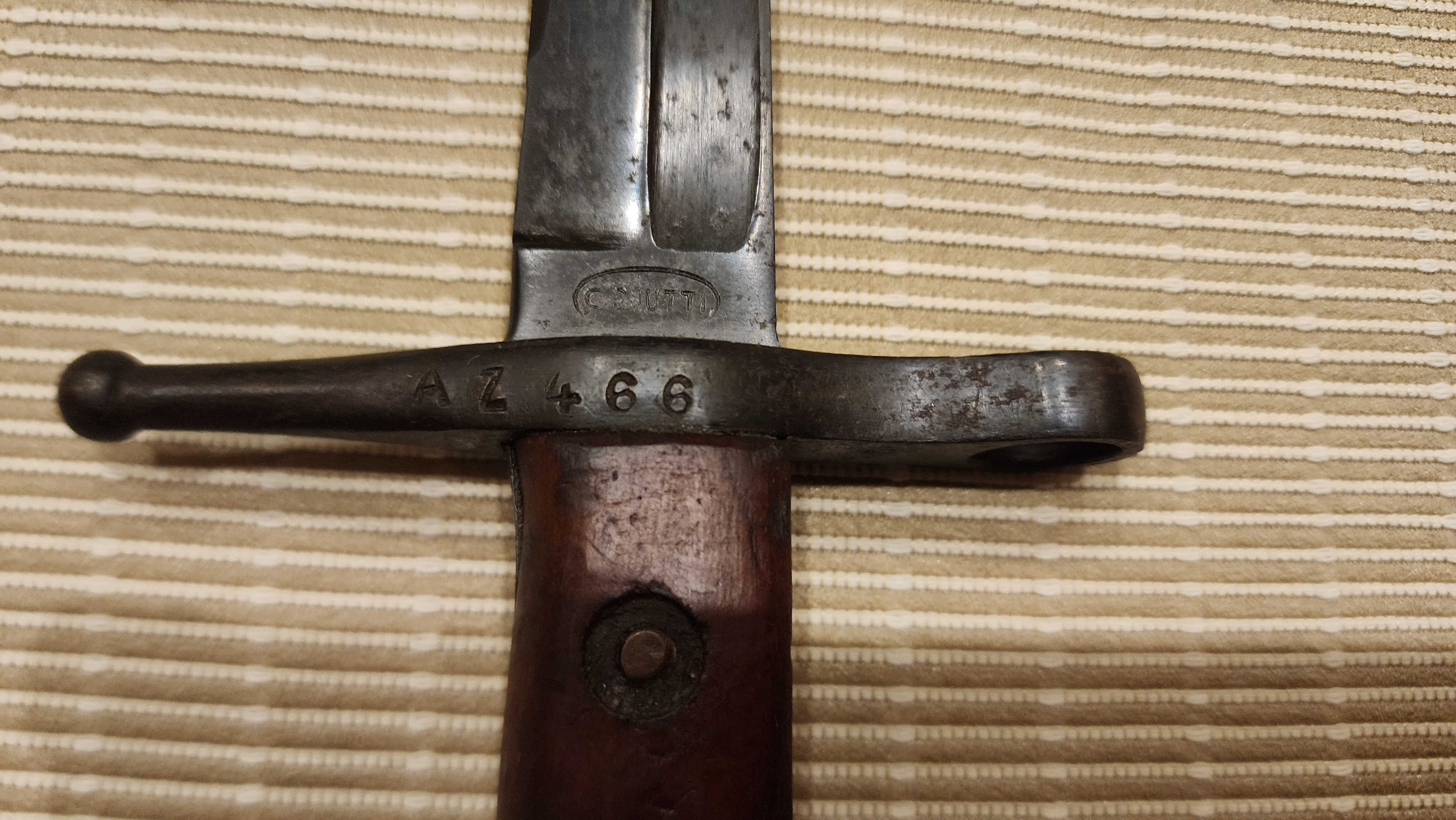 C. Gnutti maker’s mark and AZ466 serial on crossguard