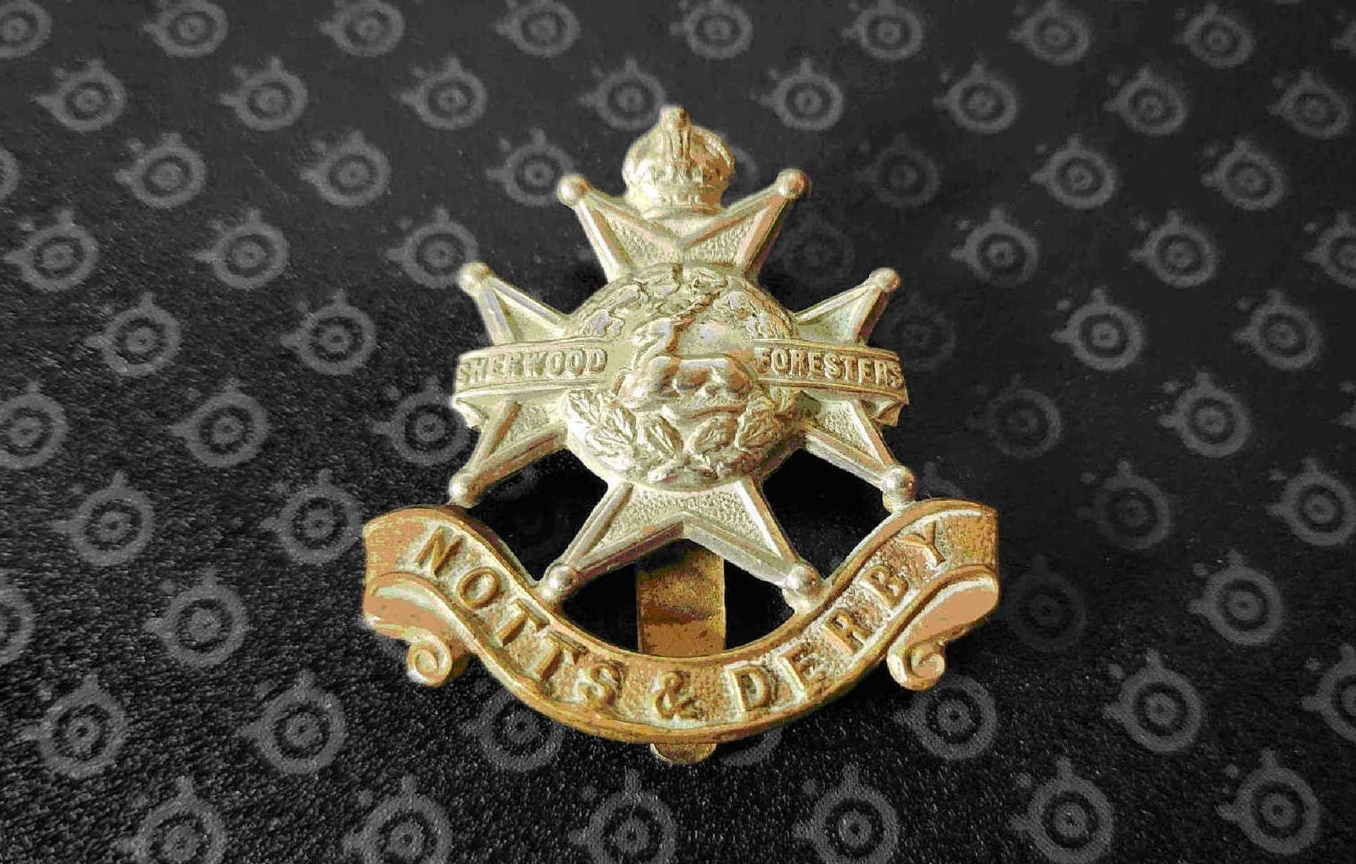 Front view of Sherwood Foresters cap badge showing stag and oak wreath on Maltese cross