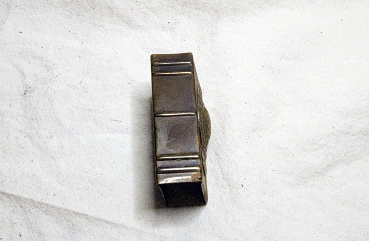 Narrow ribbed side of the brass matchbox holder