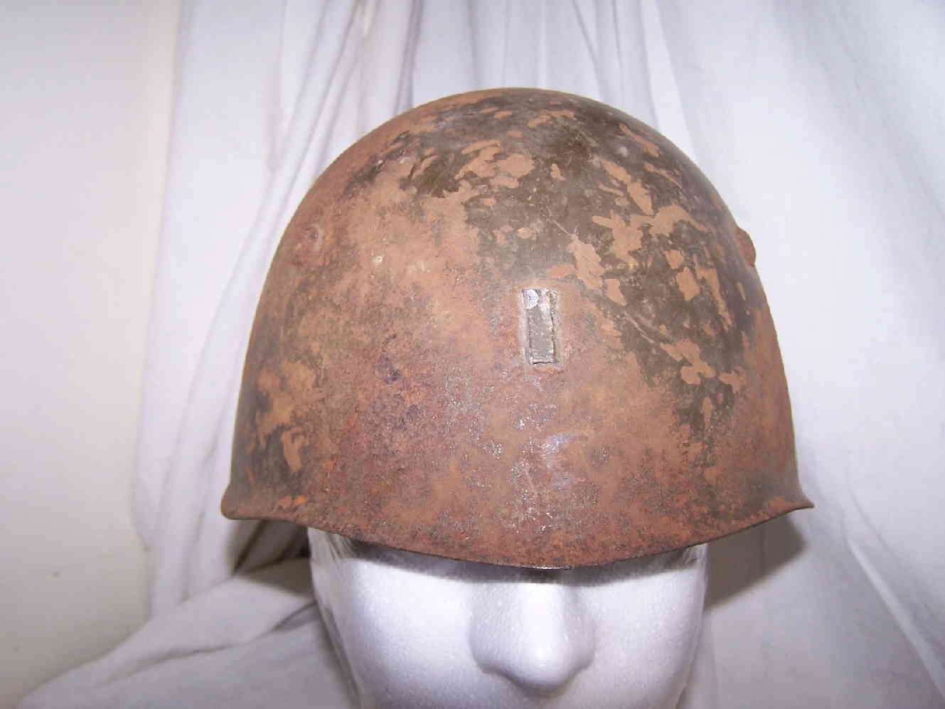Front view of Italian M33 helmet with badge scar
