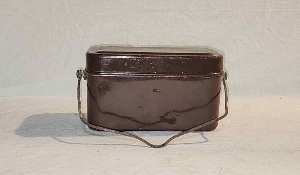 Front view of Japanese officer mess kit showing rectangular body and folding wire handle