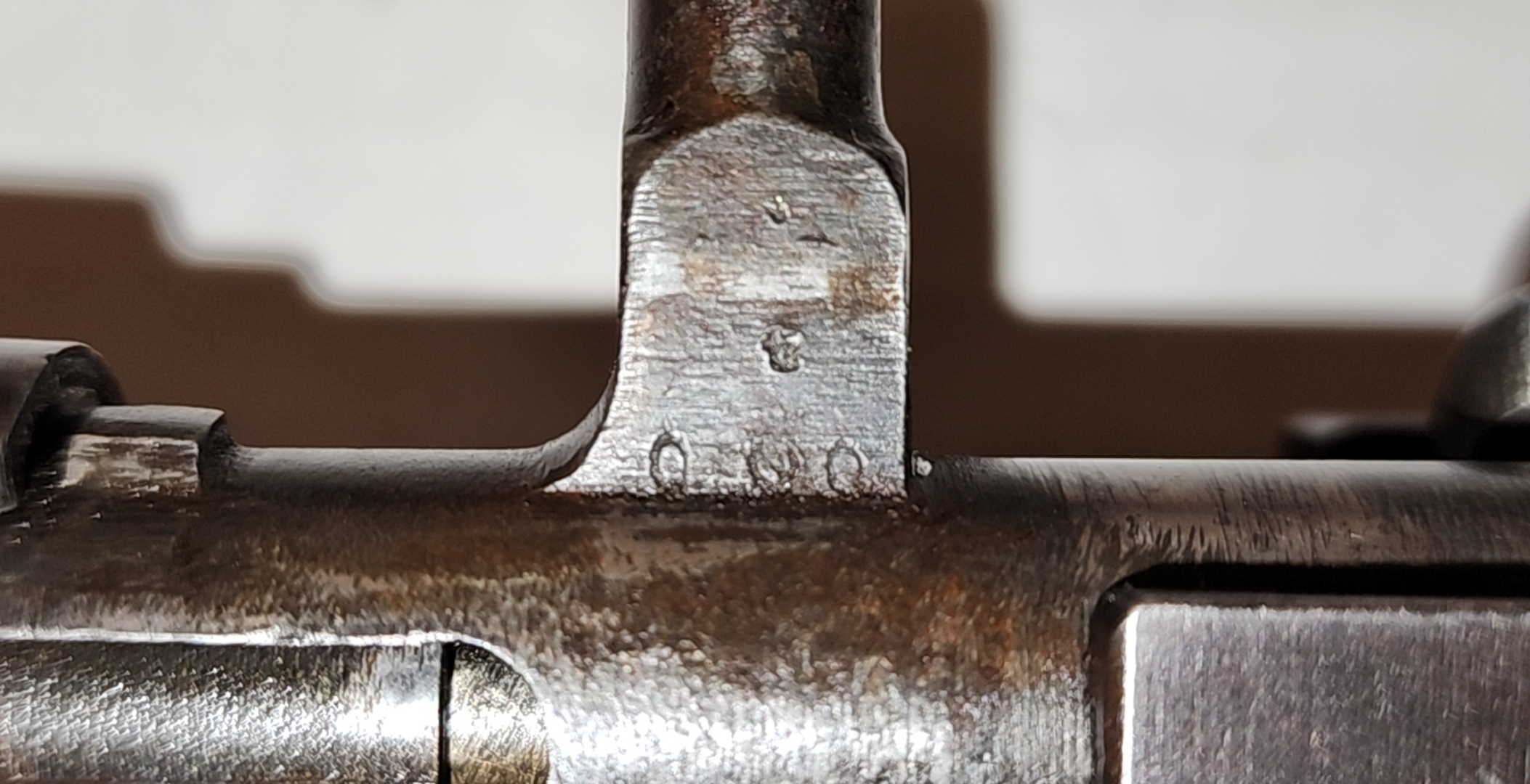 Bolt handle root serial marking on an Arisaka Type 99, showing 000