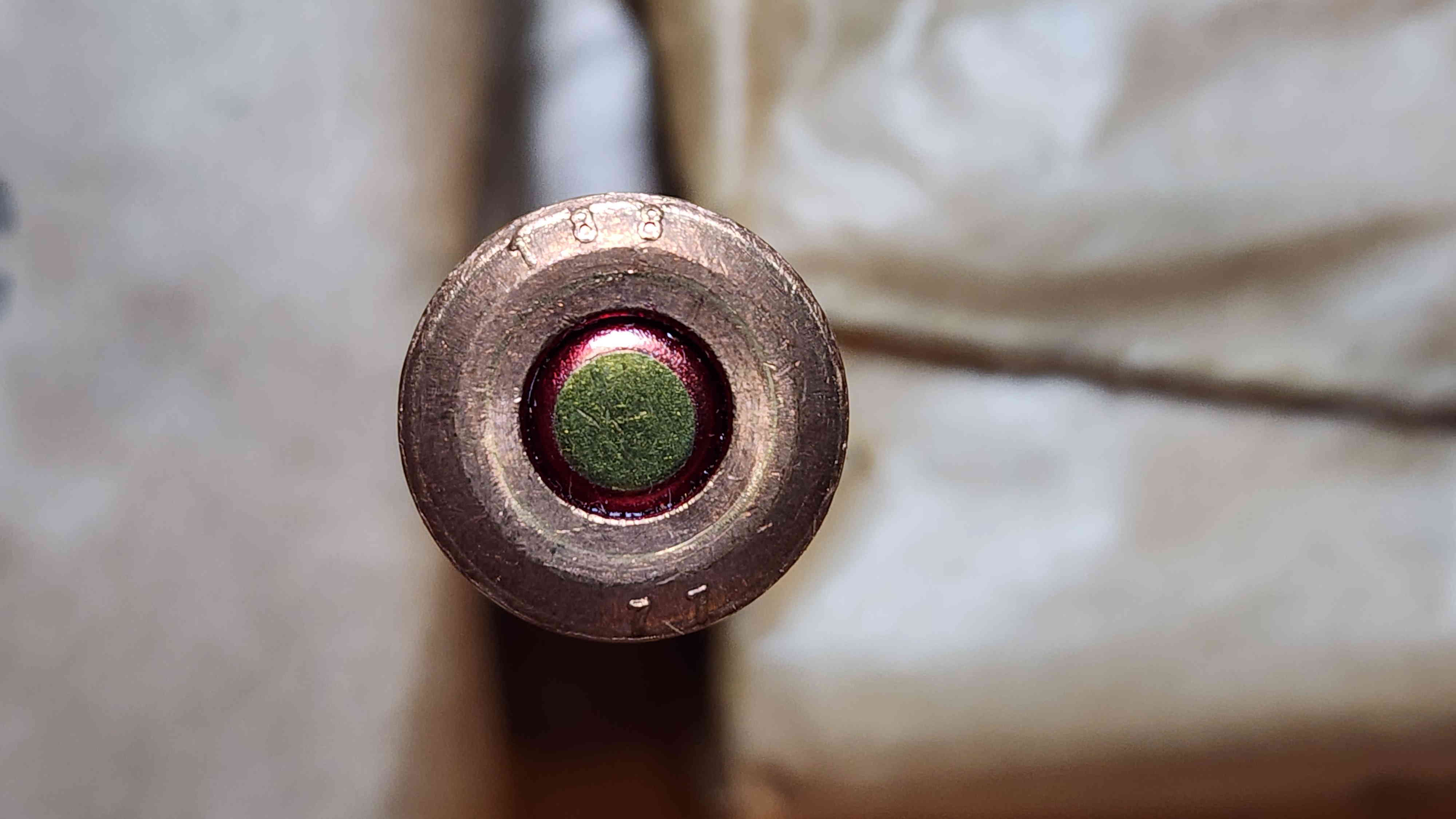 Close-up view of 7.62×54mmR cartridge with 188 over 77 headstamp