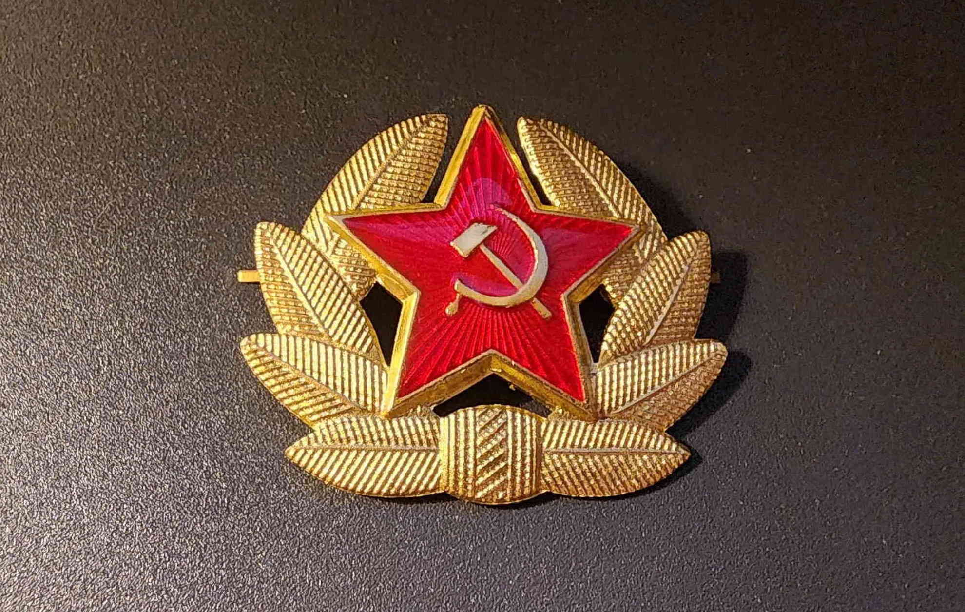 Front view of USSR officer cap cockade (kokarda) with red enamel star, hammer and sickle, and laurel wreath
