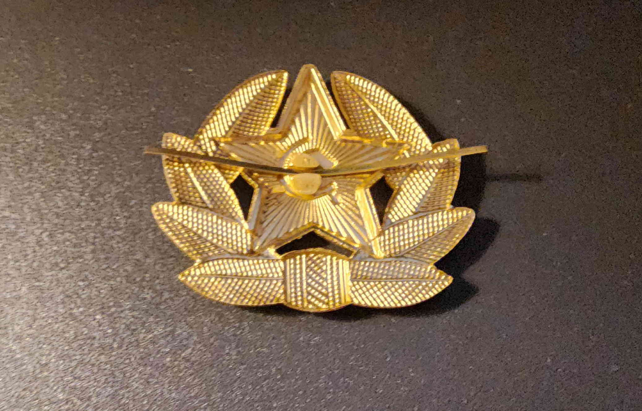 Reverse view showing horizontal pin and central soldered boss for cap attachment