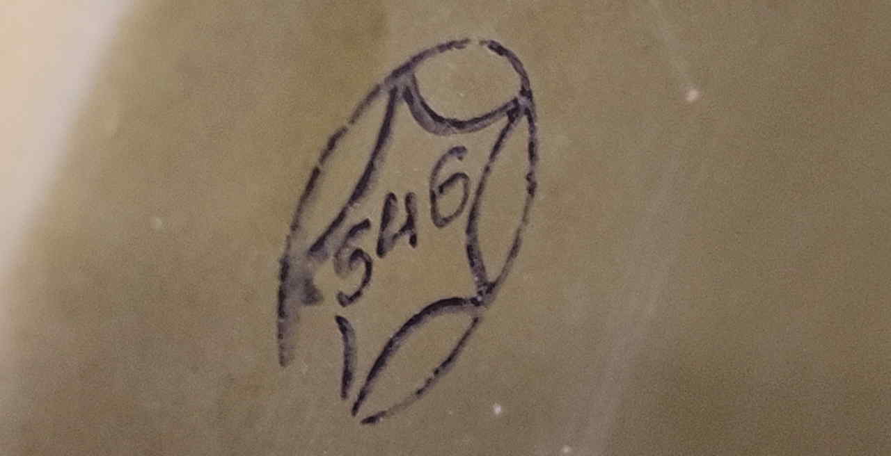Hand-applied ink notation resembling 5H6 with a star mark