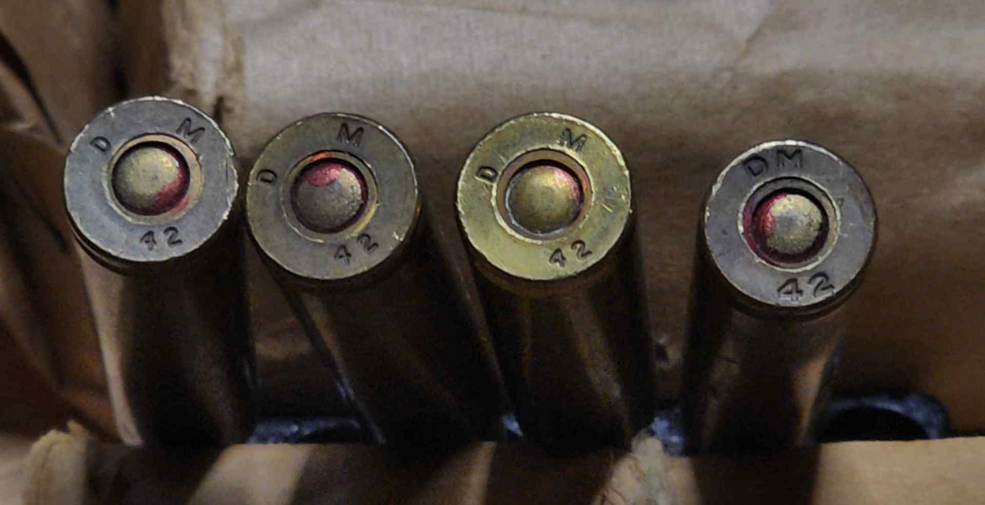 Four DM 42 cartridge headstamps showing primer sealants and spacing variations