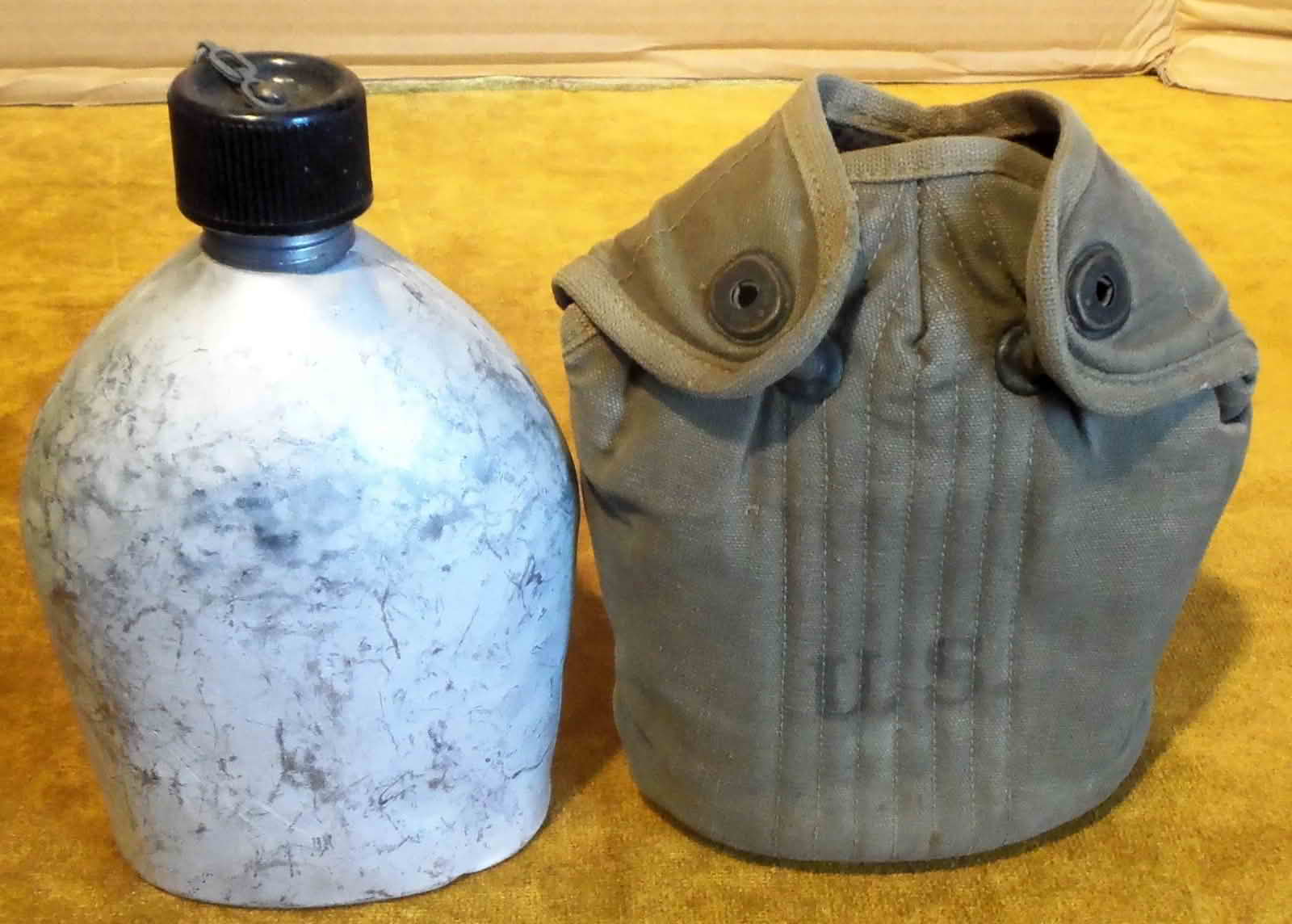 Canteen removed from the cover showing aluminum body and canvas cover