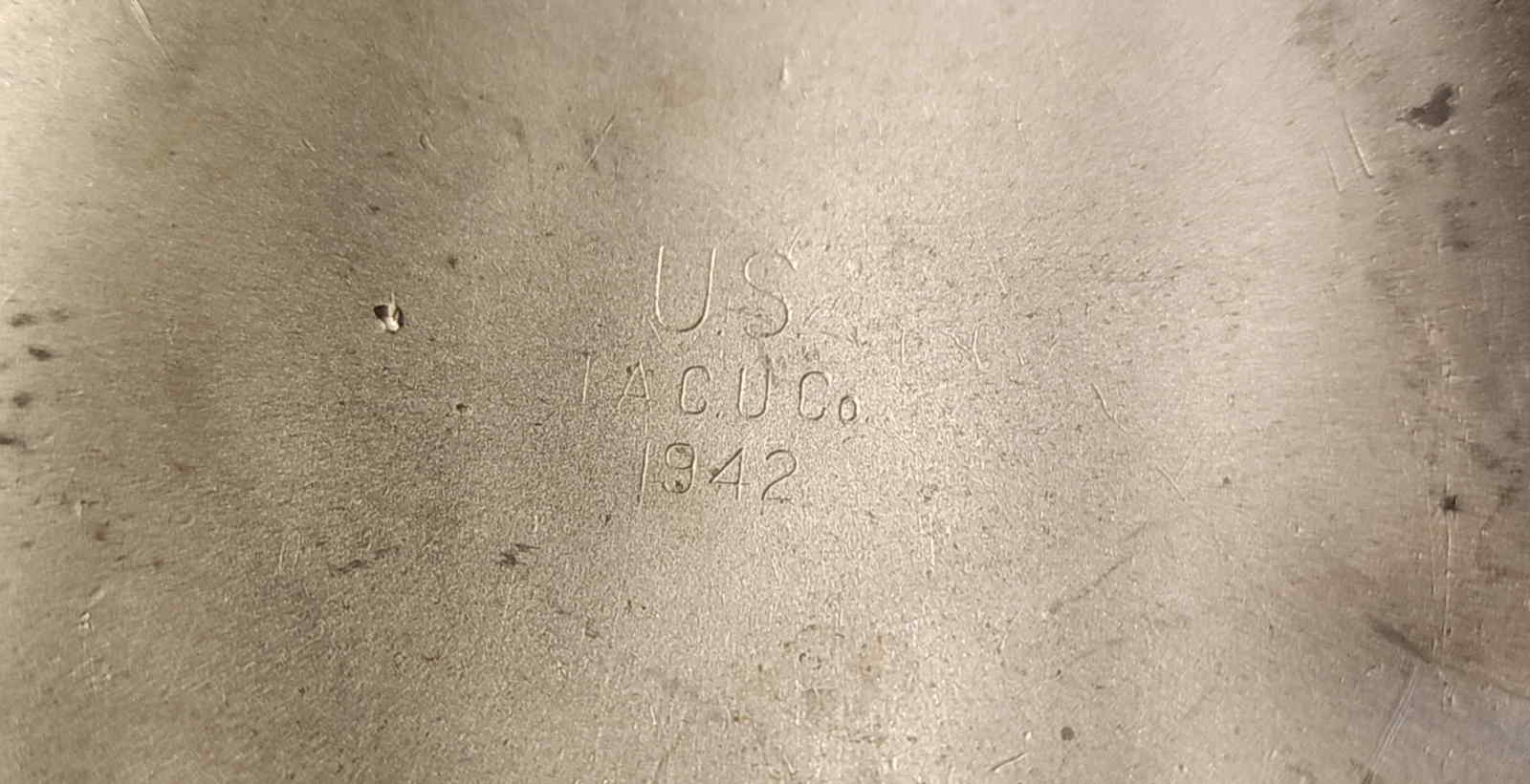 Close-up of canteen stamp reading U.S. T.A.C.U. Co. 1942