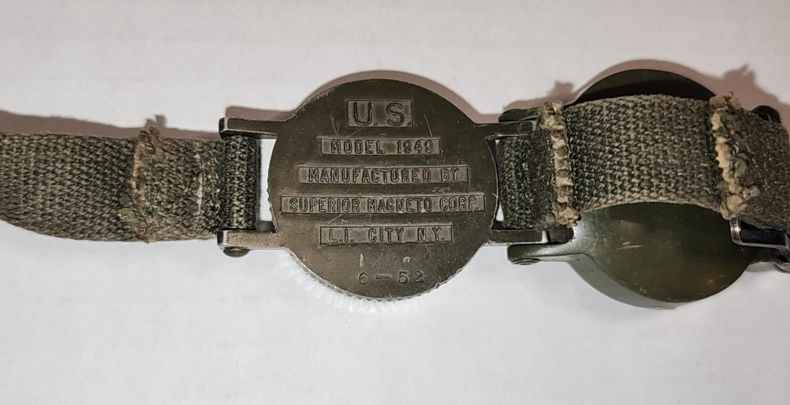 Full front view of the U.S. Model 1949 wrist compass with hinged cover and strap