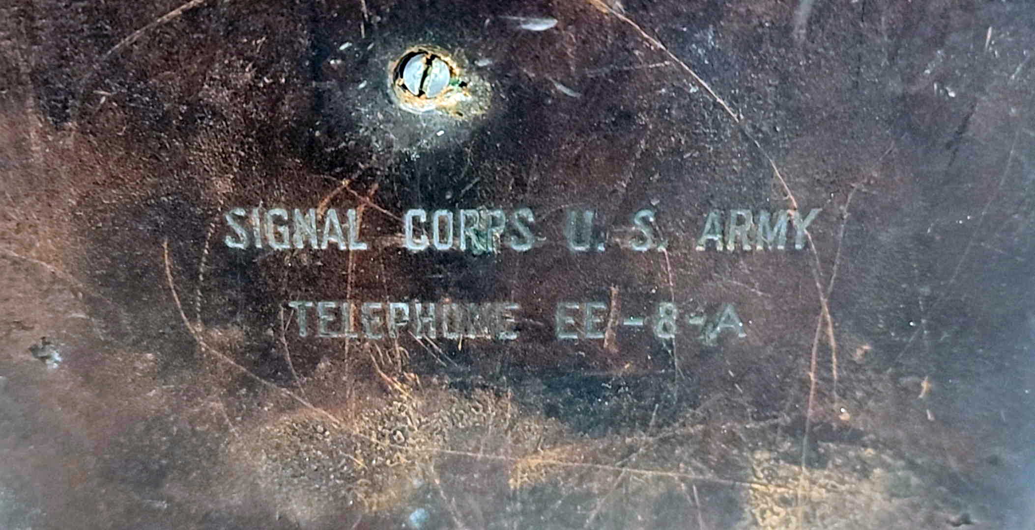 Close-up of the SIGNAL CORPS U.S. ARMY / TELEPHONE EE-8-A stamping on the leather case