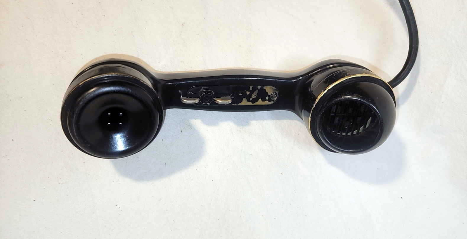 TS-9-H handset used with the EE-8-A field telephone, showing receiver, mouthpiece spit cup guard, and push-to-talk lever