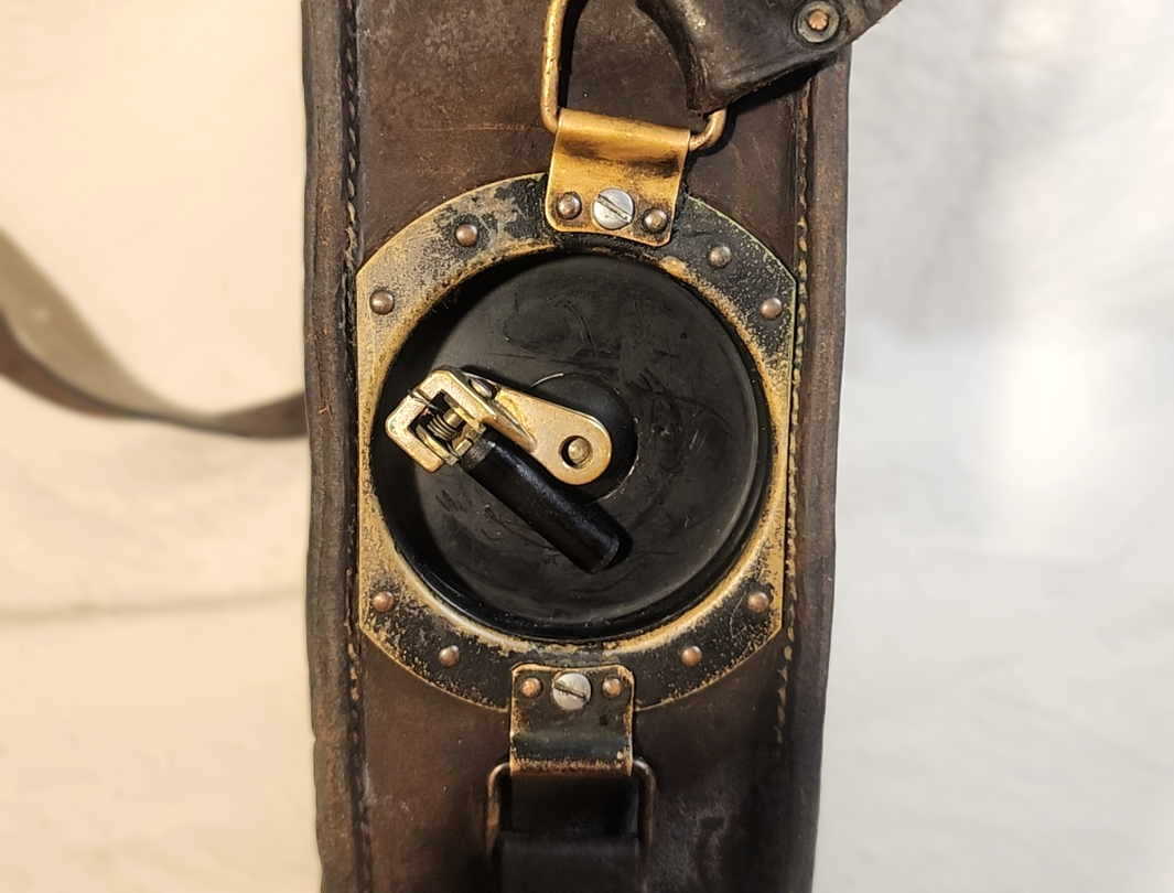 Close-up of the EE-8-A hand-crank generator GN-38 on the side of the leather case