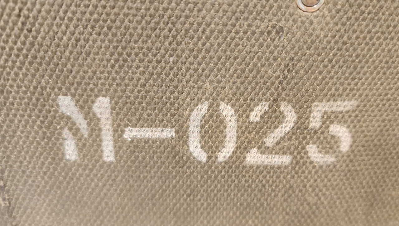 Rear of the EE-8-B canvas case showing stenciled marking M-025
