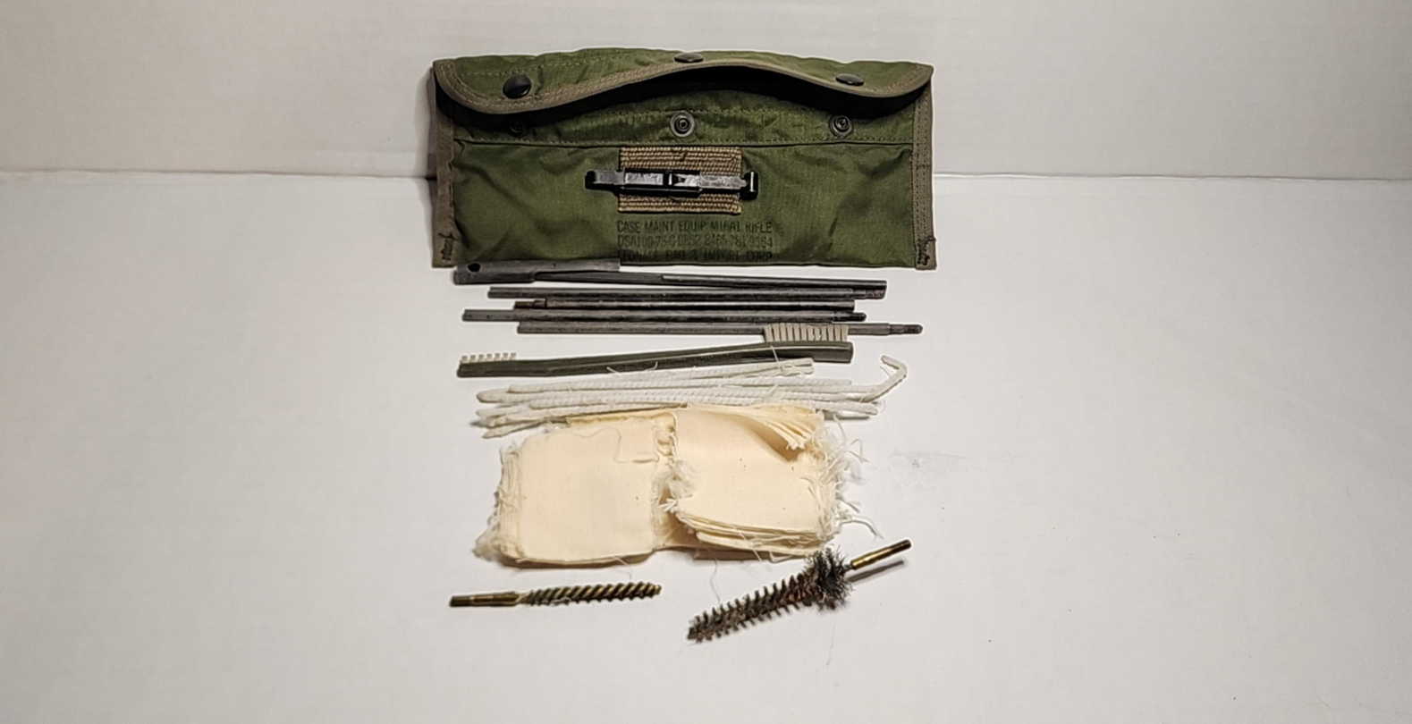 Rifle cleaning kit laid out with contents displayed