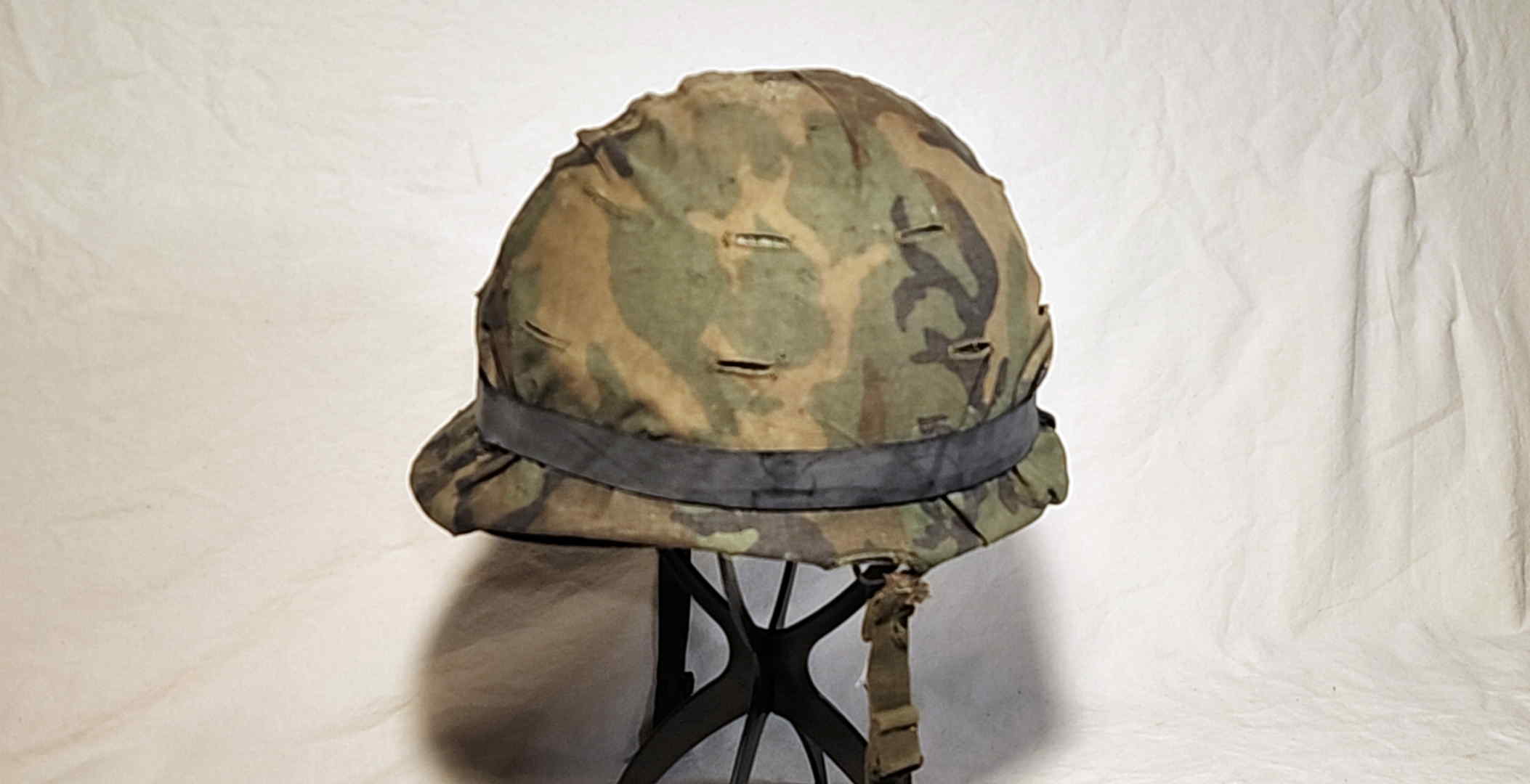 Field-expedient inner-tube helmet band fitted over ERDL cover