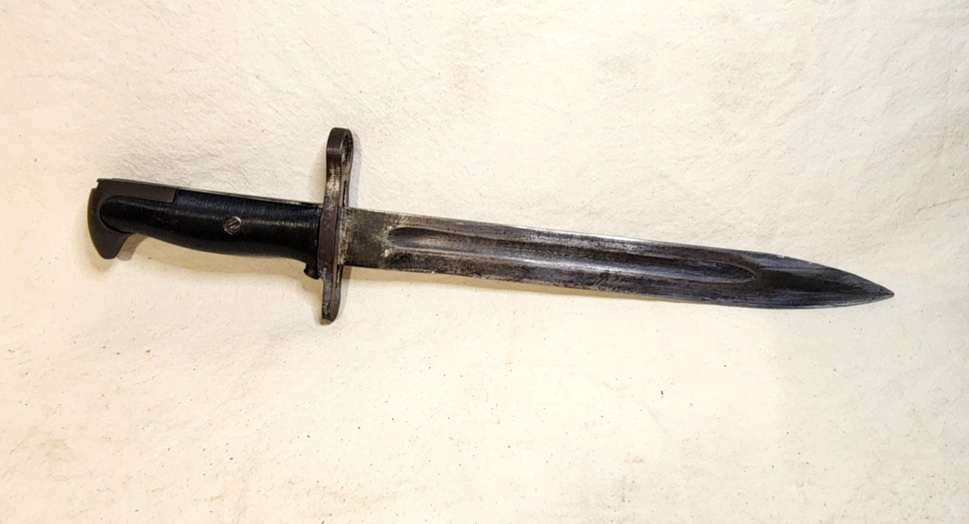 Opposite unmarked face of the fullered M1 bayonet blade showing its spear point