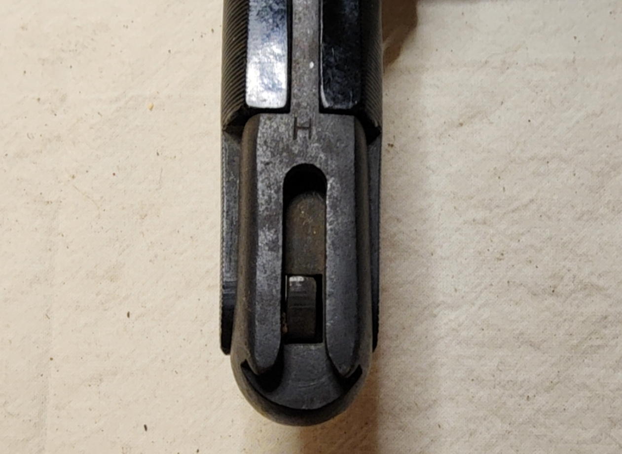 Close view of the H stamp near the T-shaped rifle mounting slot in the bayonet pommel