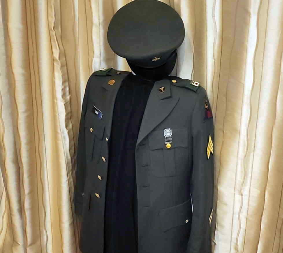 Preserved Army Green service coat and enlisted service cap with original insignia