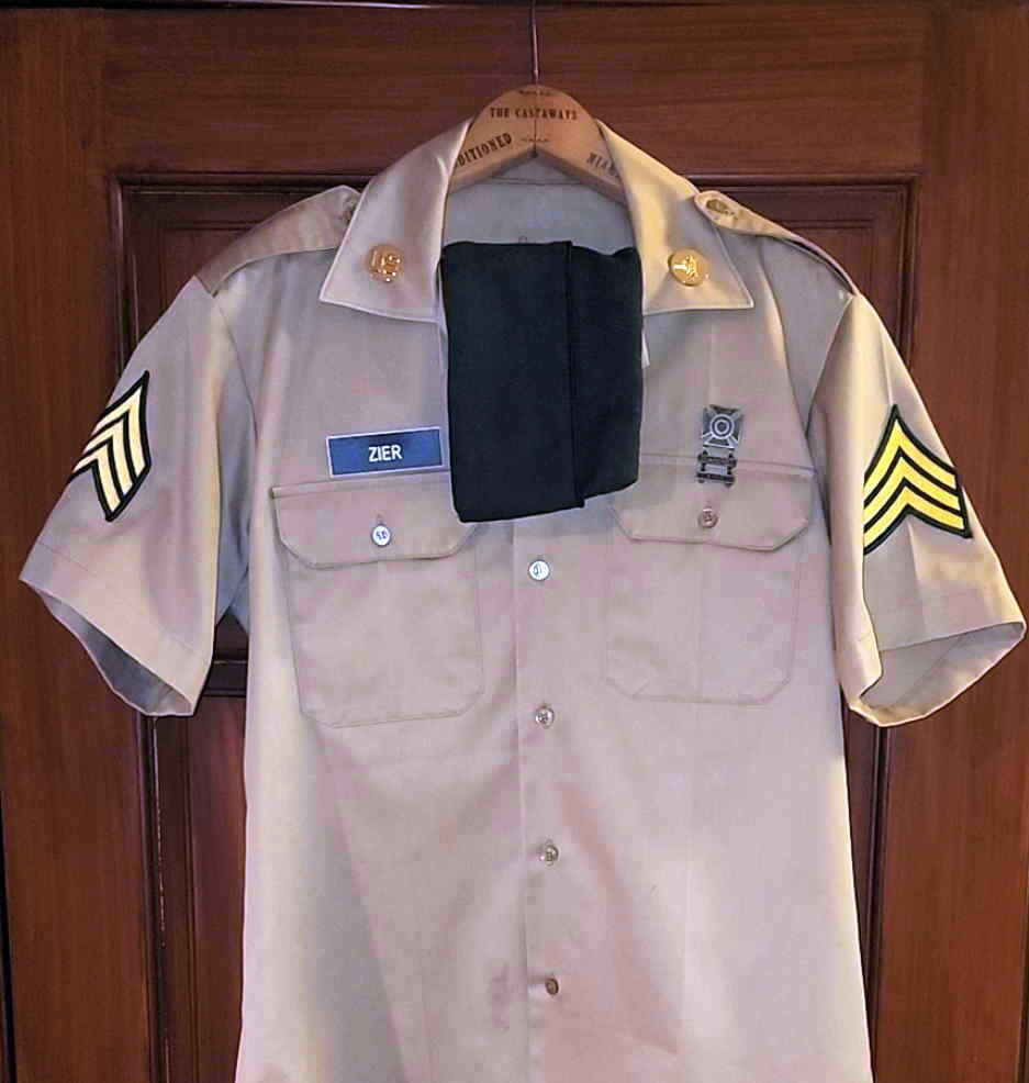 Preserved short-sleeve Army Khaki shirt with original insignia, qualification badge, and Army Green garrison cap
